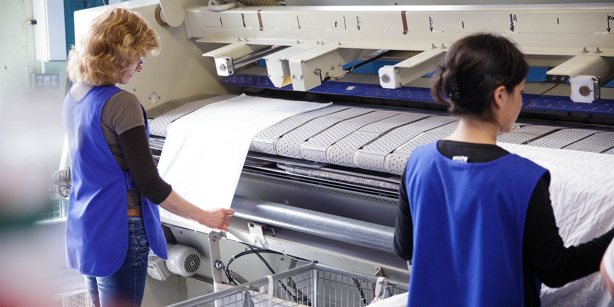 Members of staff drying fresh laundry